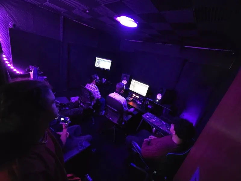 The whole room from the corner — the session up on both screens