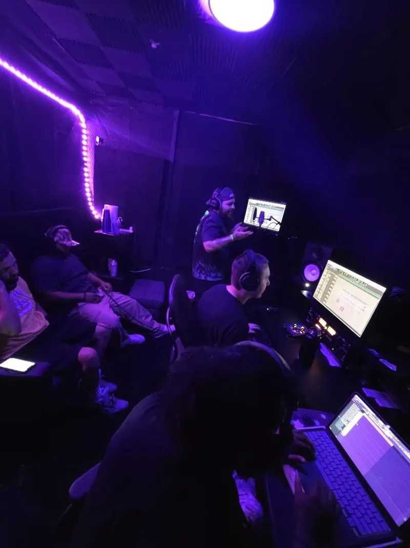 The couch session — mic in the shockmount, phone up, the desk rolling behind