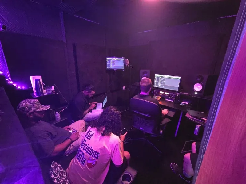 Heads down all around the room — laptop open, verses going into phones