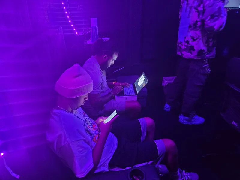 Over by the wall with the laptop