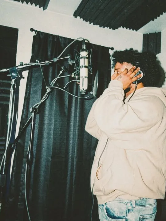 On the mic, headphones on