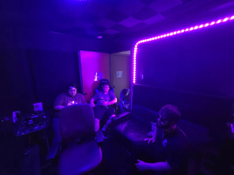 The lounge under the strip light — a break between takes