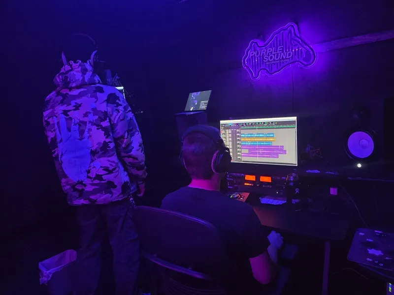 Two at the board under the neon