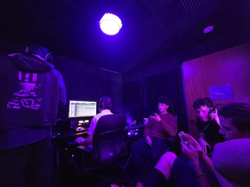 Everybody in — the Welcome to Purple Sound sign on the door and the whole room under the purple light